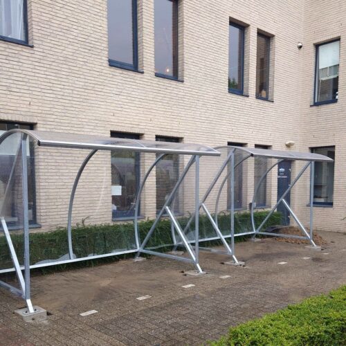 Fietsoverkapping BF1000 – Halfrond & Transparant 226 Twee fietsenstallingen bij een gebouw.