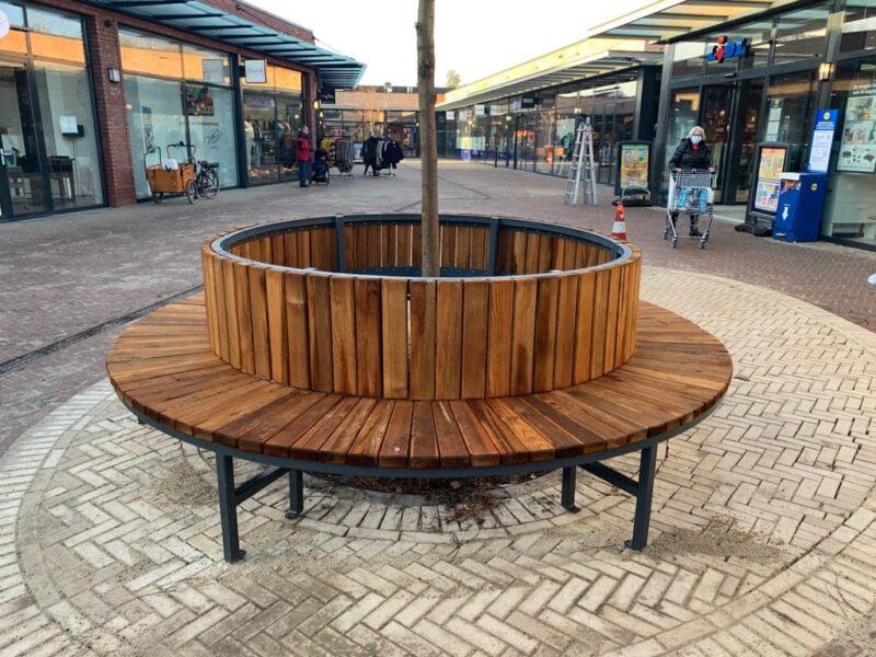 Hout, staal of gerecycled kunststof: welke materiaalkeuze biedt de laagste TCO voor parkmeubilair? 2 Ronde boombank in winkelcentrum, toegepast in een intensief gebruikte openbare ruimte